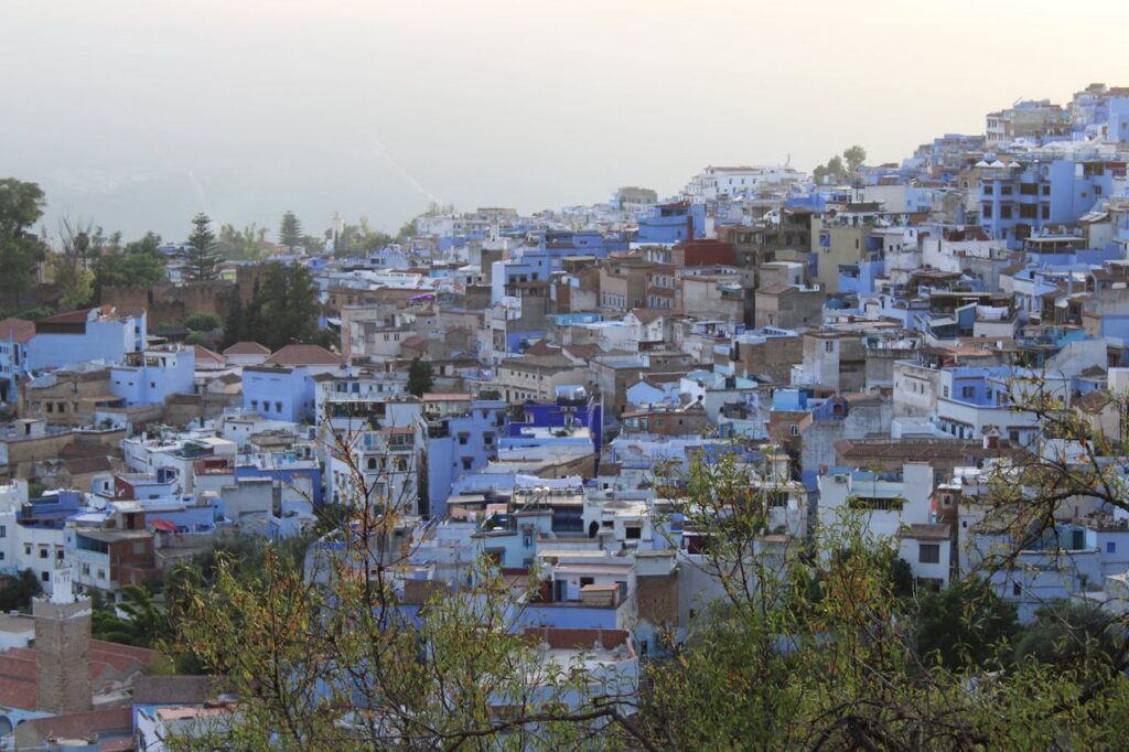 A stunning view of Chefchaouen's iconic blue buildings nestled in the hills of Morocco.